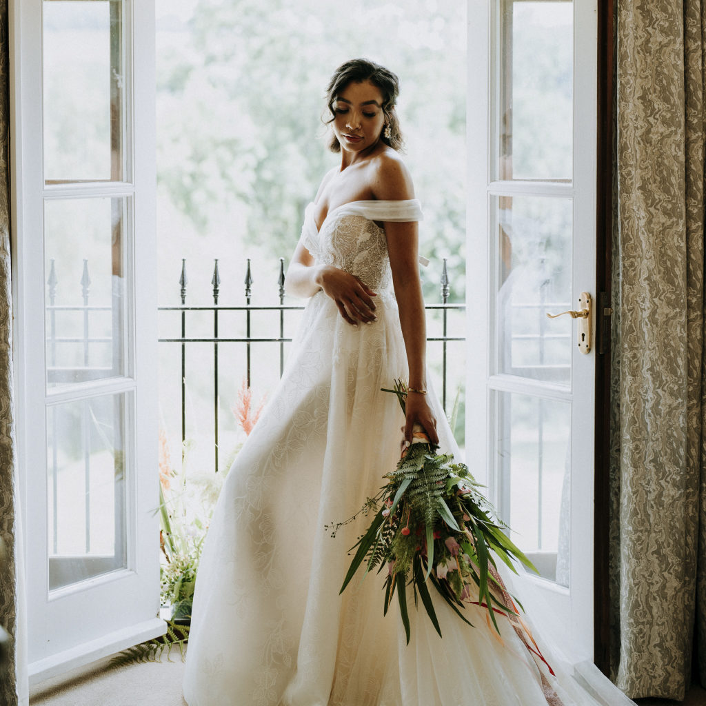 Beautiful Bride Stood in the Double Doorway by the Balcony