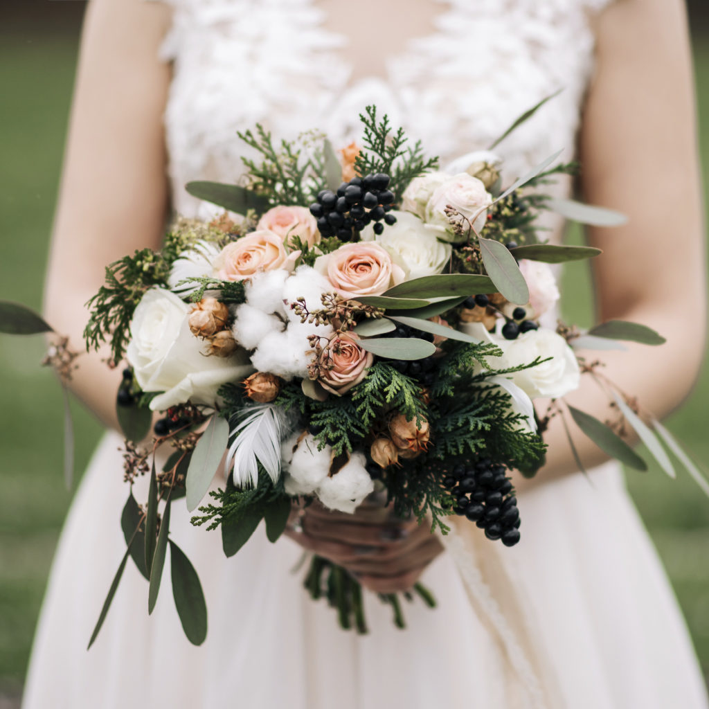 Bride Holding Pretty Bouquet of White and Peach Flowers with Greenery Detail