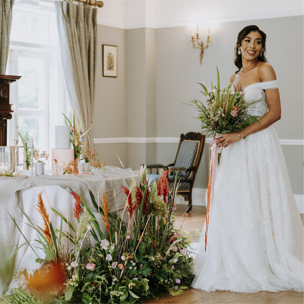 Bride at Her Wedding Reception Holding Flowers and Looking into the Distance