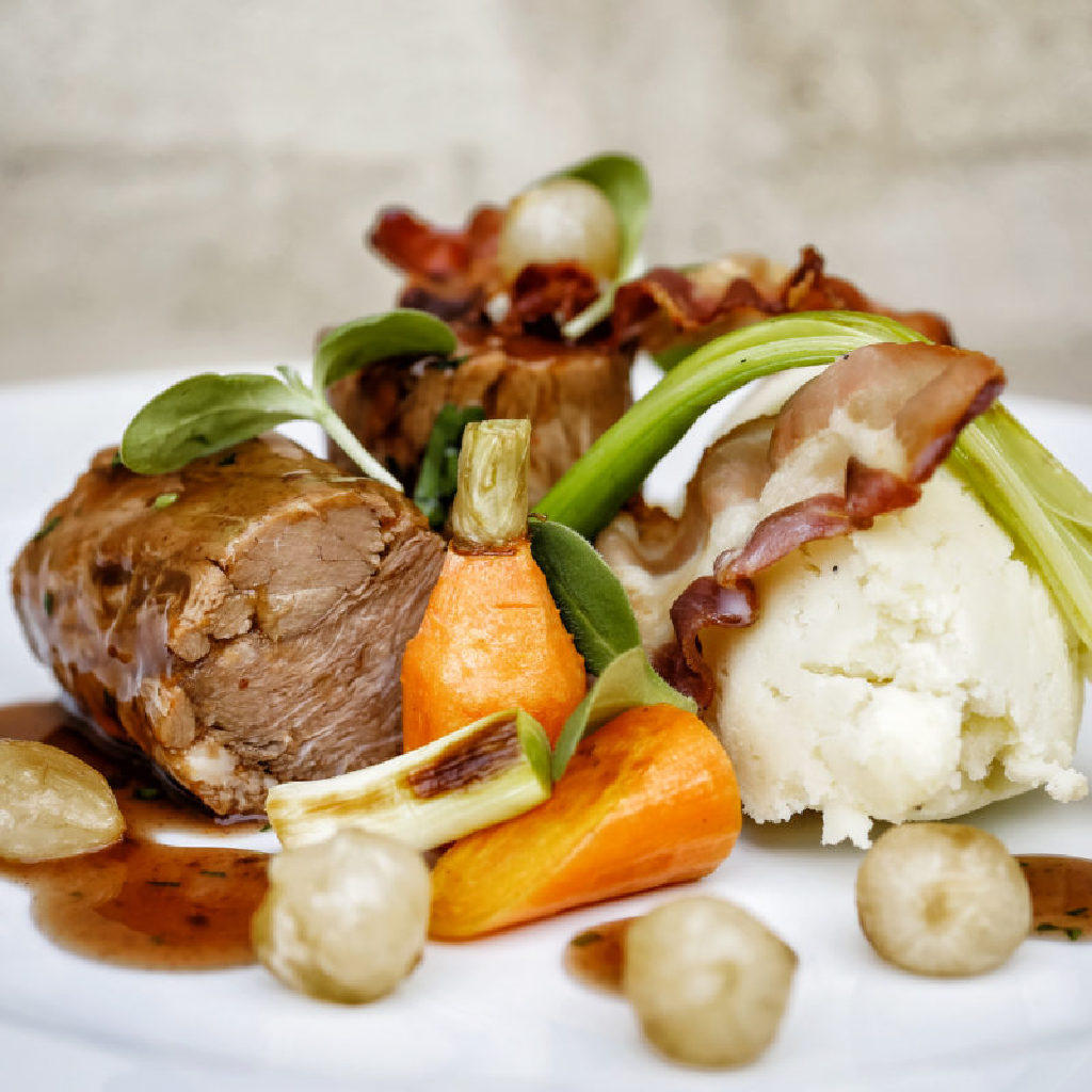 Meal of Meat and Vegetables on a Plate Presented in a Professional Manner