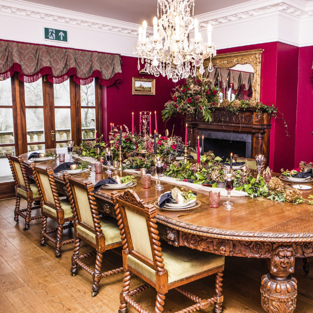 The Dining Room with Dramatic Red Walls and Full Set Table with Candles