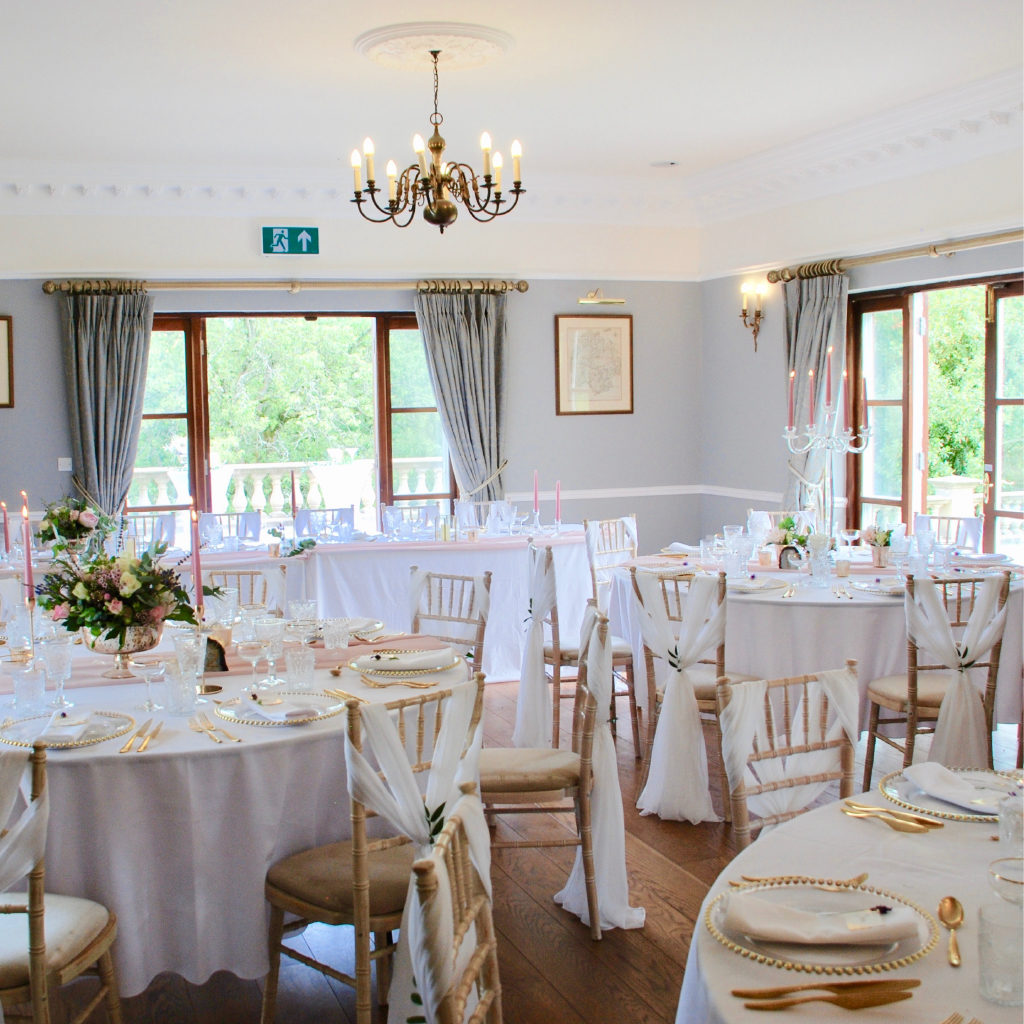 The Drawing Room with Chair Covers and Set Tables with Floral Centre Pieces